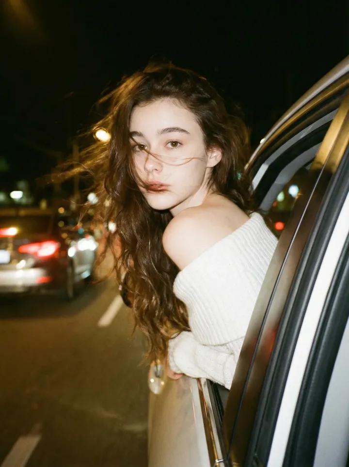 Wearing an off-shoulder white knit top