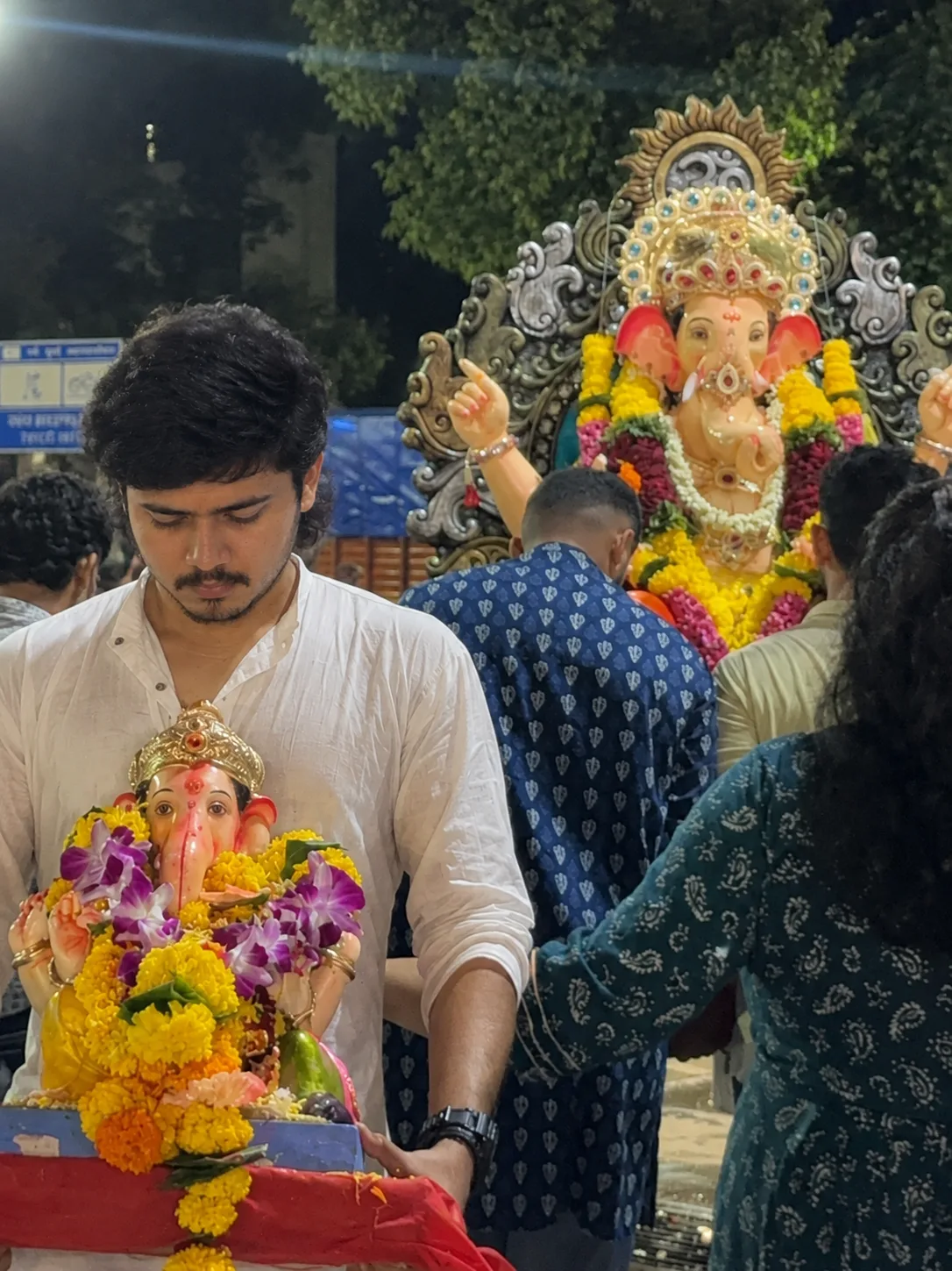 A realistic nighttime Ganesh Chaturthi celebration in India.