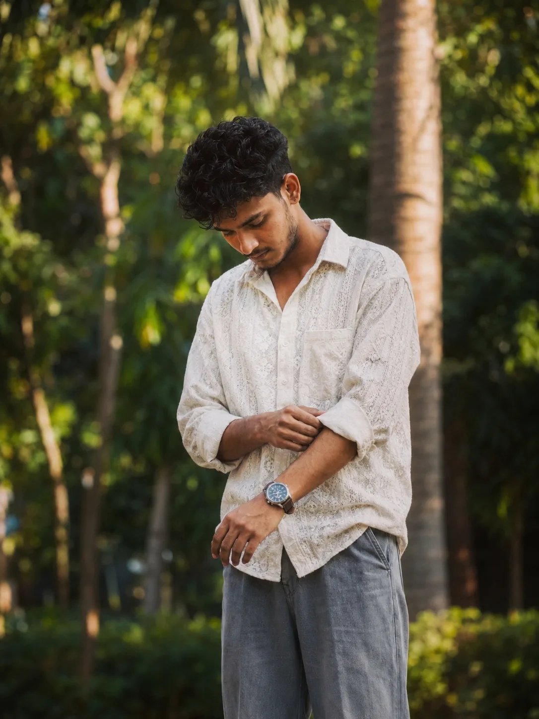 Ultra-realistic cinematic outdoor portrait of a young Indian man, preserving the exact facial features, hairstyle, beard, skin tone, facial
