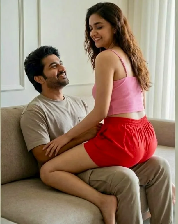 A photorealistic vertical medium shot of the young South Asian couple from the reference image, faithfully preserving their exact
