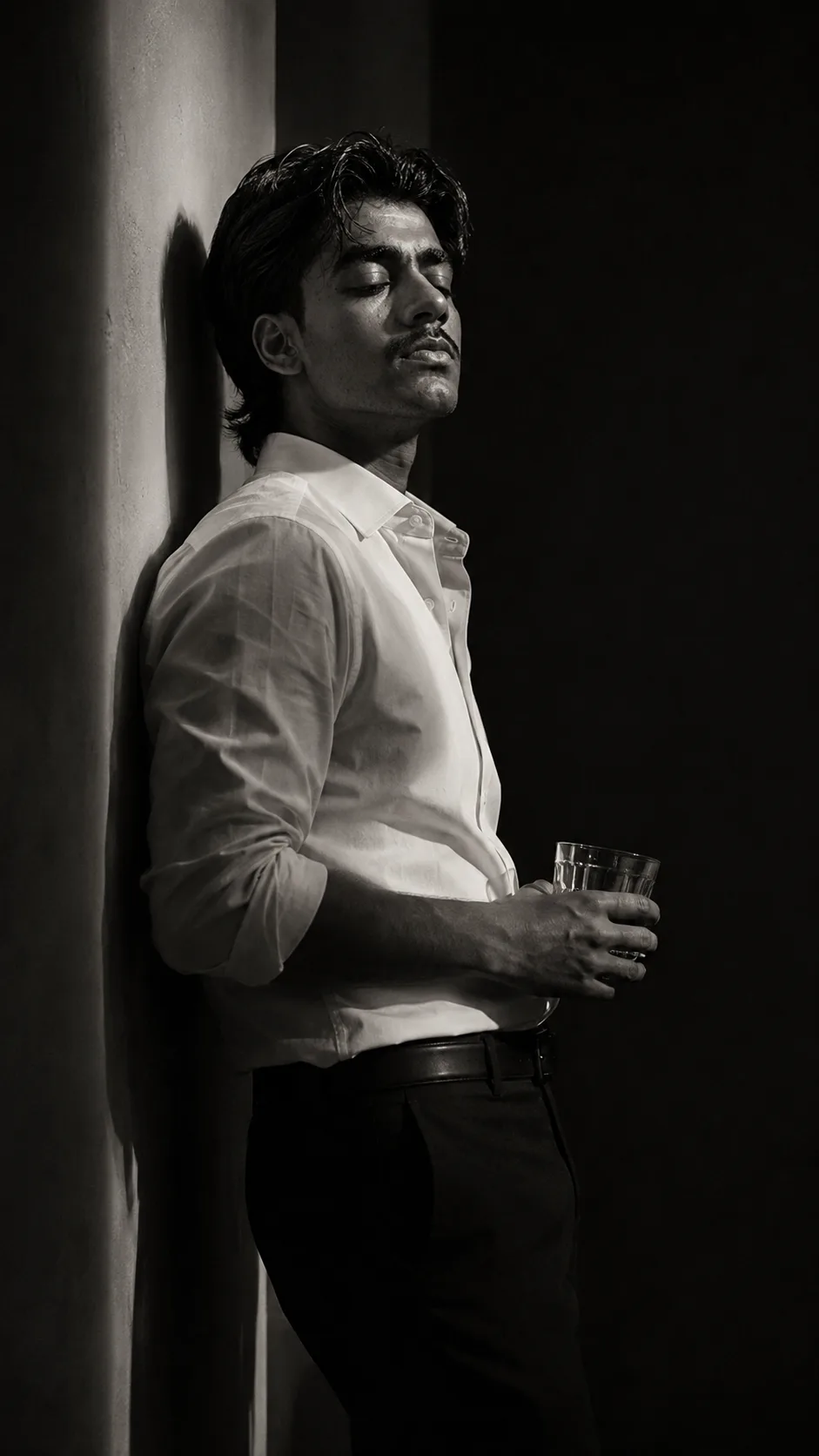 Exact Image Recreation Prompt Create a highly photorealistic cinematic black-and-white portrait photograph of a young adult man standing