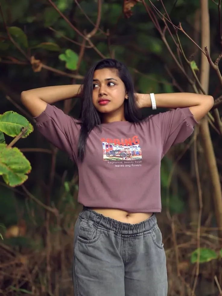 A photorealistic vertical medium shot in exact 3:4 aspect ratio capturing the young South Asian woman from the reference image standing