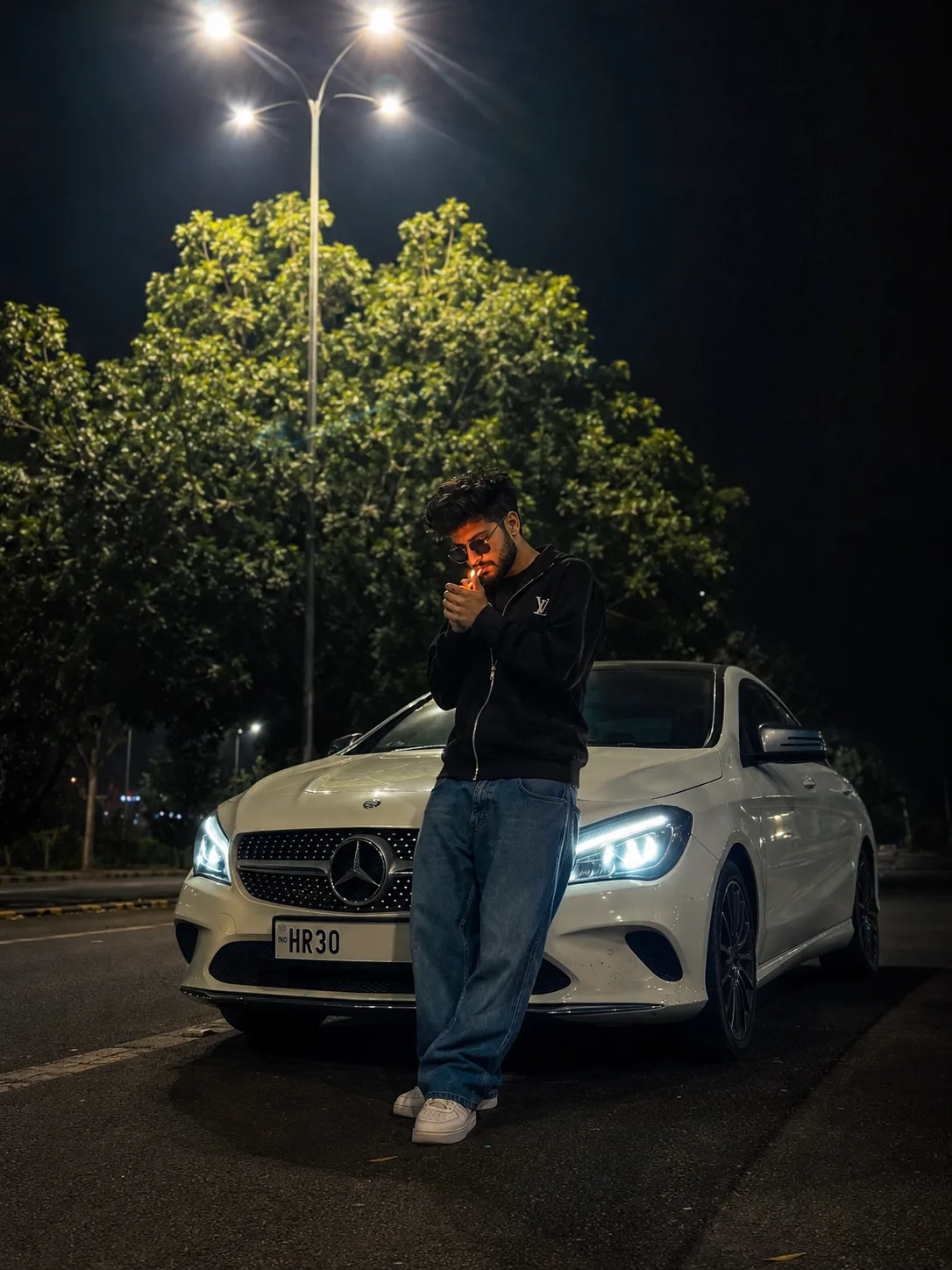 Cinematic ultra-realistic night street photography of a young bearded man leaning against the front of a white Mercedes-Benz CLA Coupe with