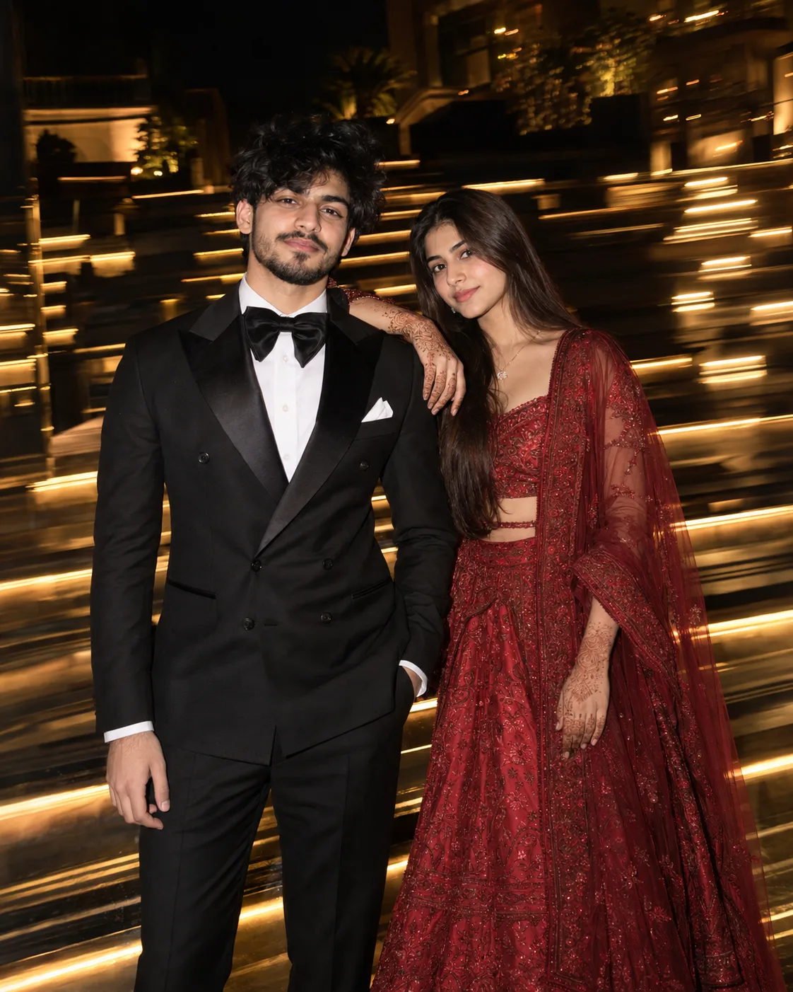 Create an ultra-realistic, high-resolution vertical 4:5 nighttime event photograph of a young South Asian couple posing closely together on