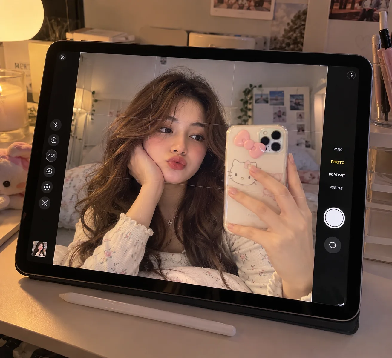 A close-up photo of an iPad pro resting on a desk, displaying an active camera app UI.