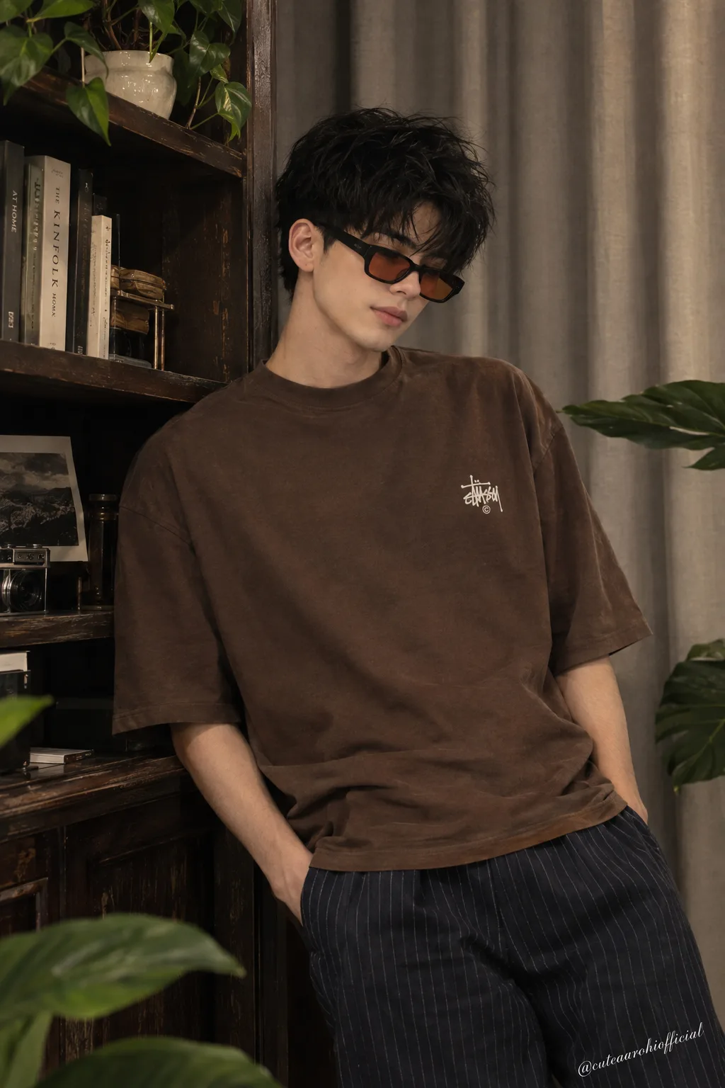 A candid medium shot of a stylish young Asian man with messy, textured black hair, leaning against a dark vintage wooden bookshelf.