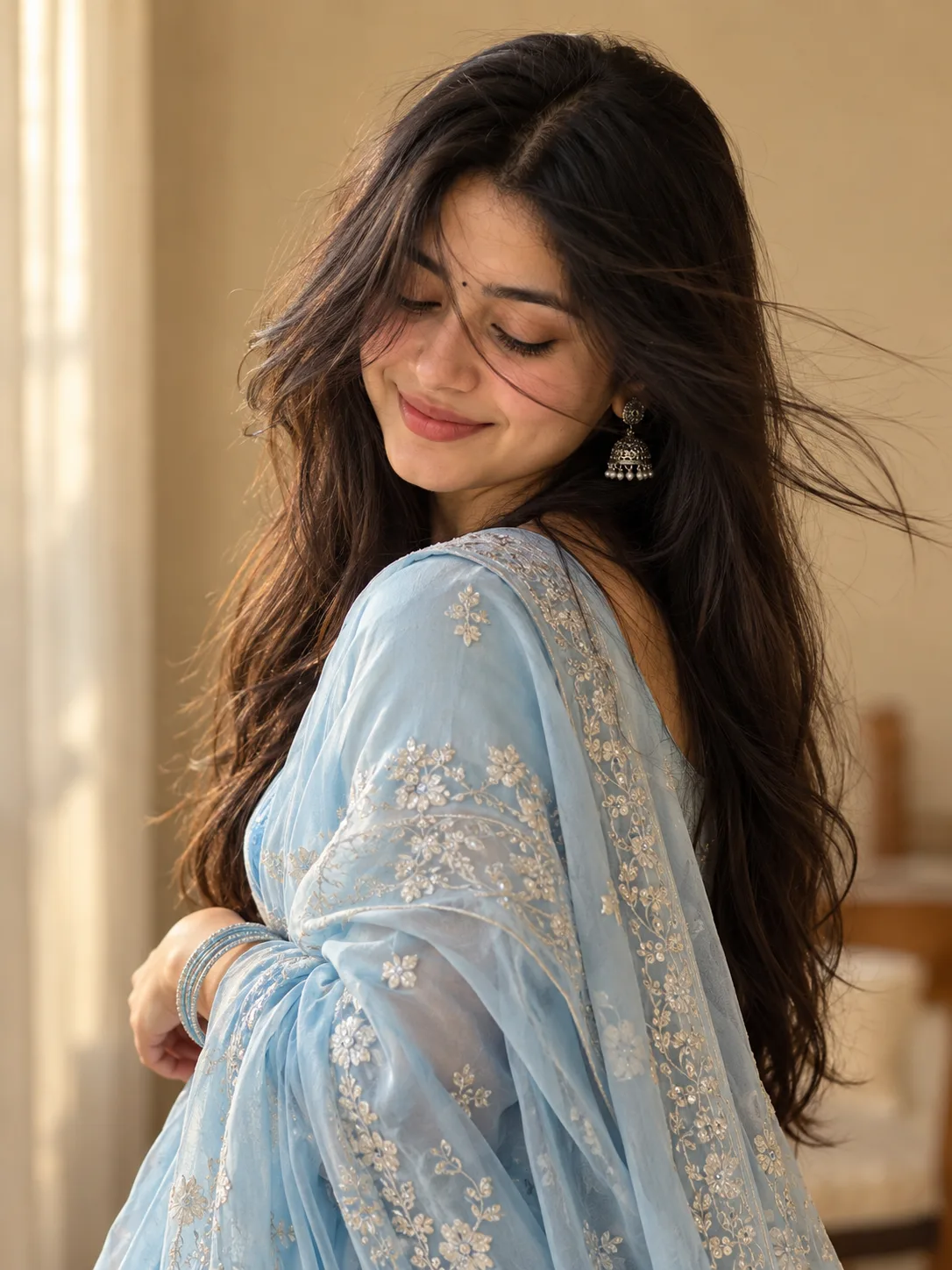> Create a photorealistic portrait of a young South Asian woman in a soft powder-blue embroidered traditional outfit with delicate silver