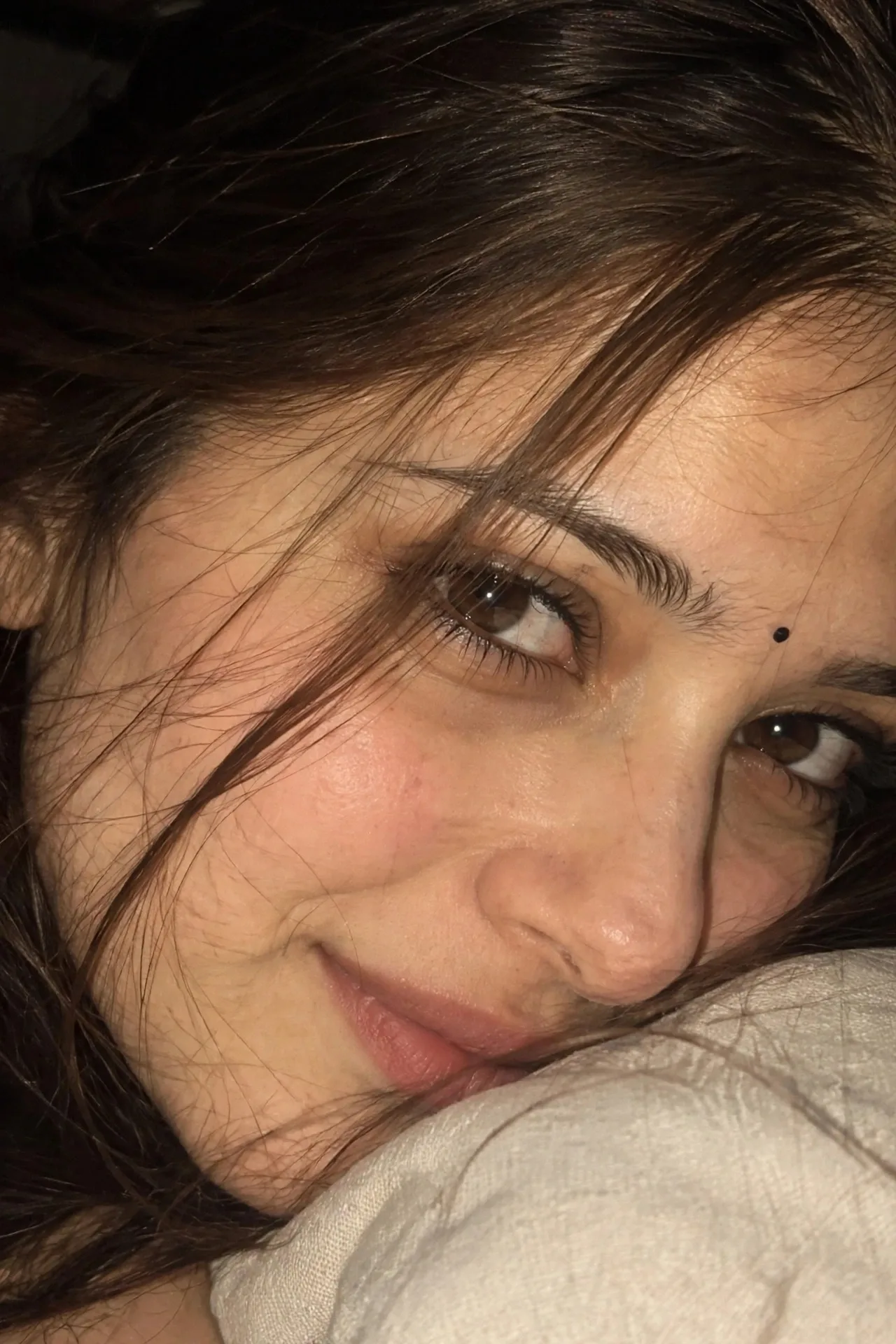 Ultra-realistic extreme close-up macro portrait of the same person, 3/4 side angle, focus on both eyes, a few soft hair strands naturally