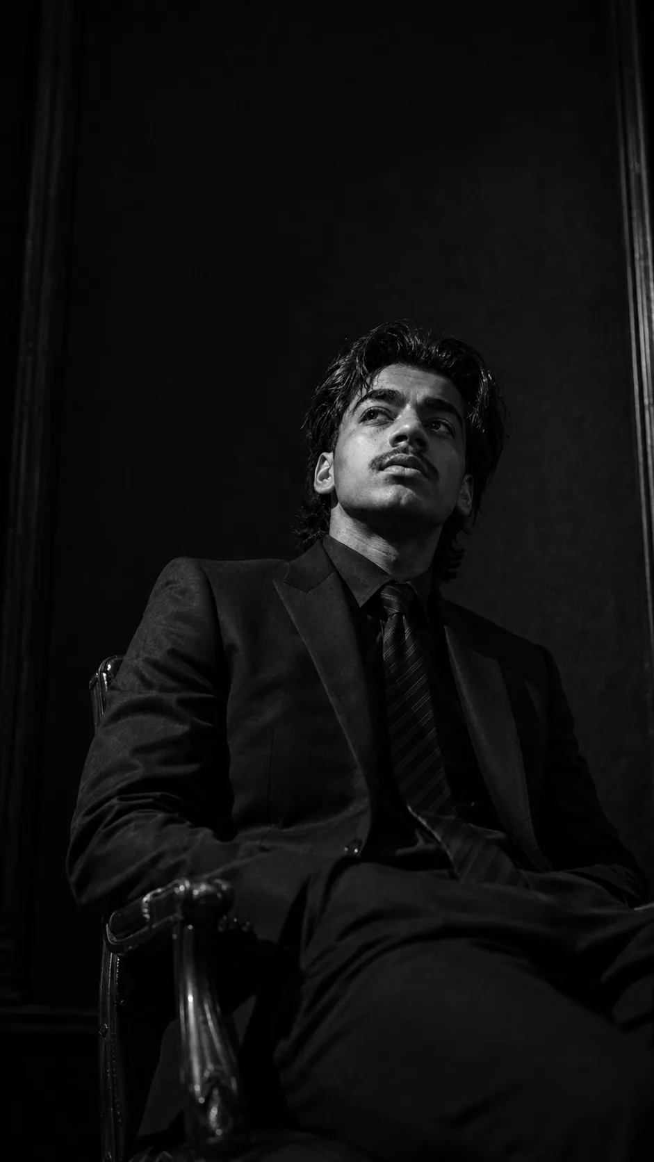 Create an ultra-realistic black-and-white cinematic editorial portrait that closely recreates the provided reference image, preserving the