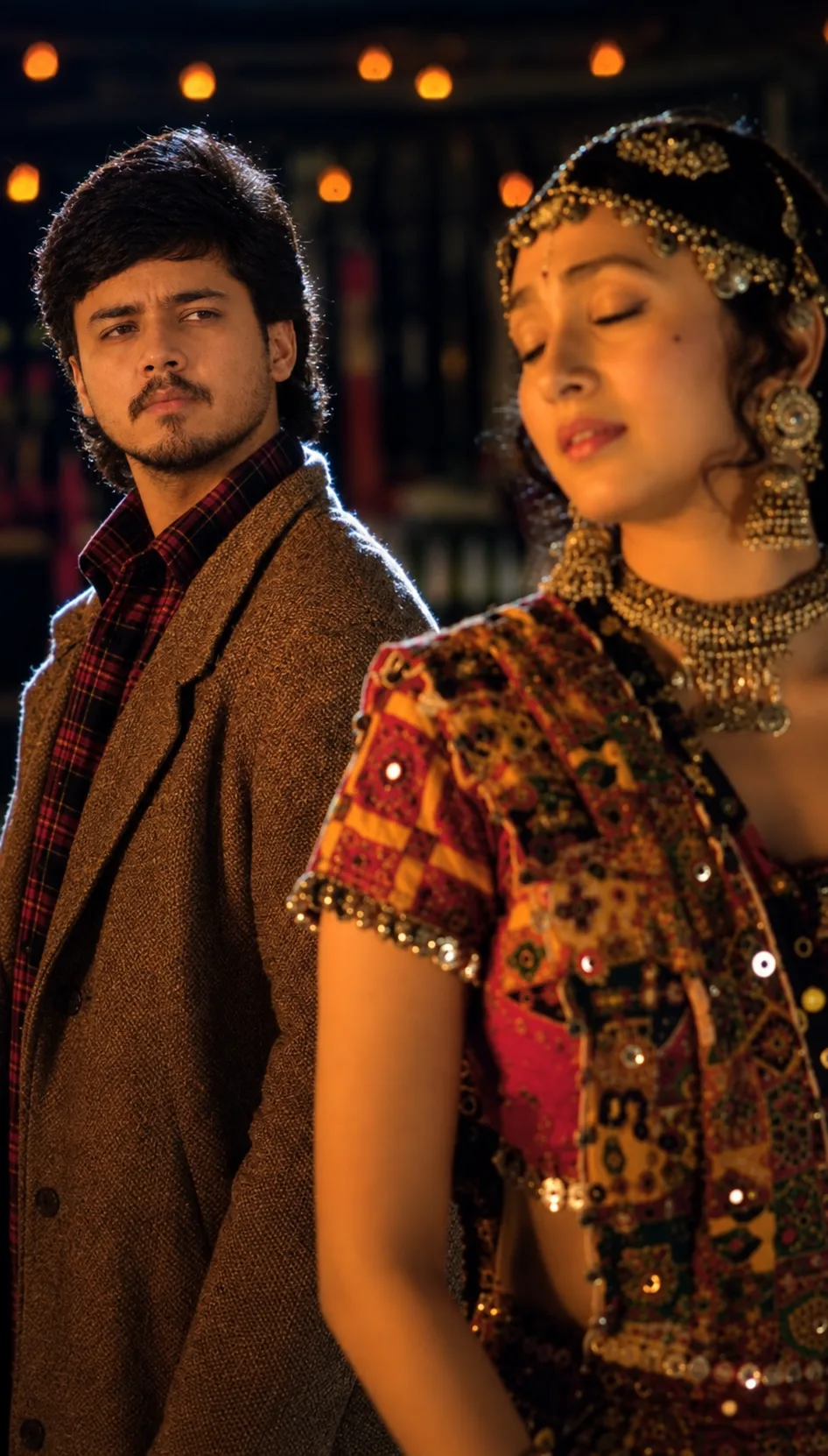 Ultra-realistic cinematic vertical portrait of a young South Asian man standing slightly behind a woman in an intimate nighttime setting.