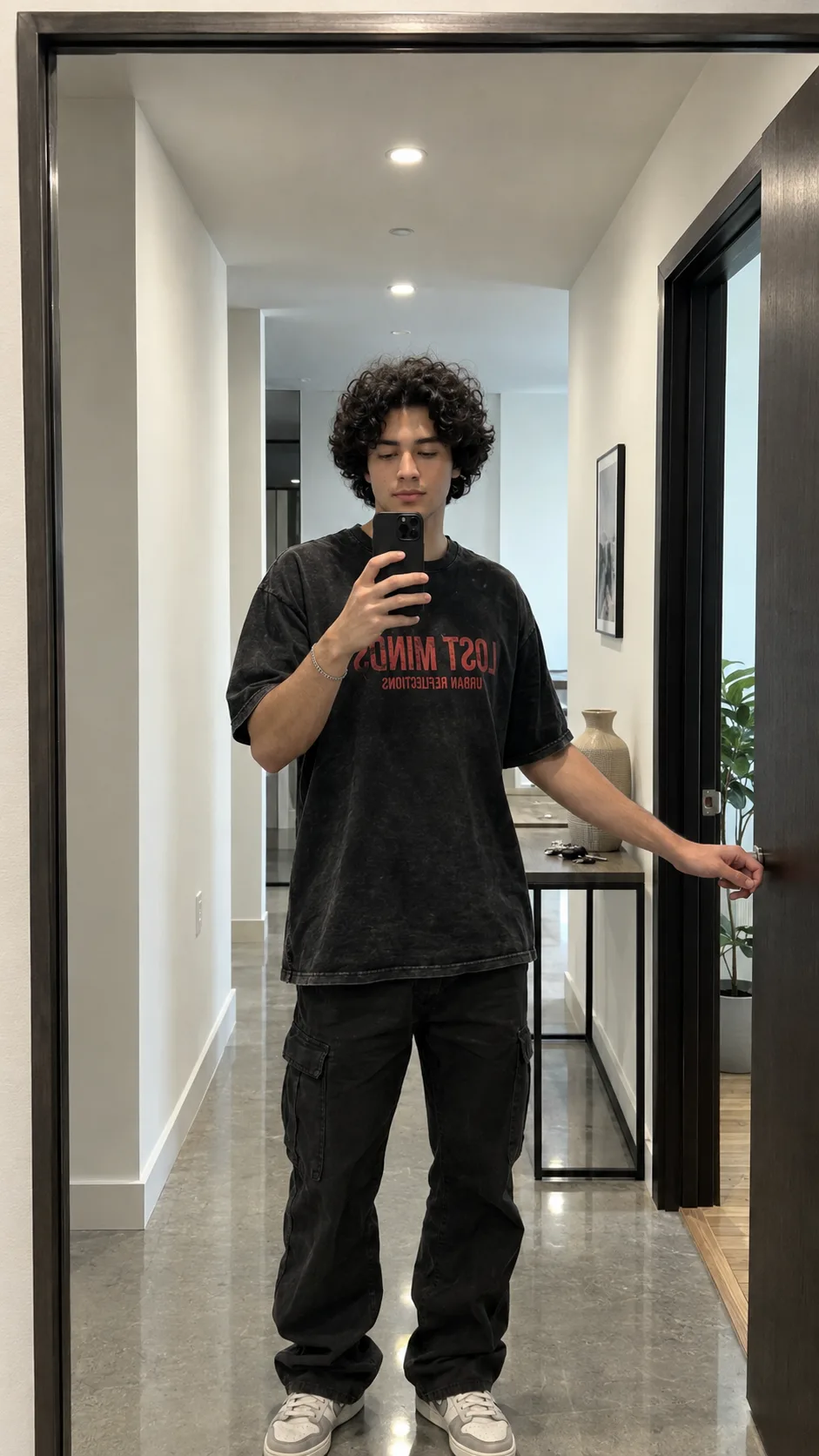 Create an ultra-realistic, premium cinematic mirror-selfie portrait of a young male standing casually in a sophisticated modern residential