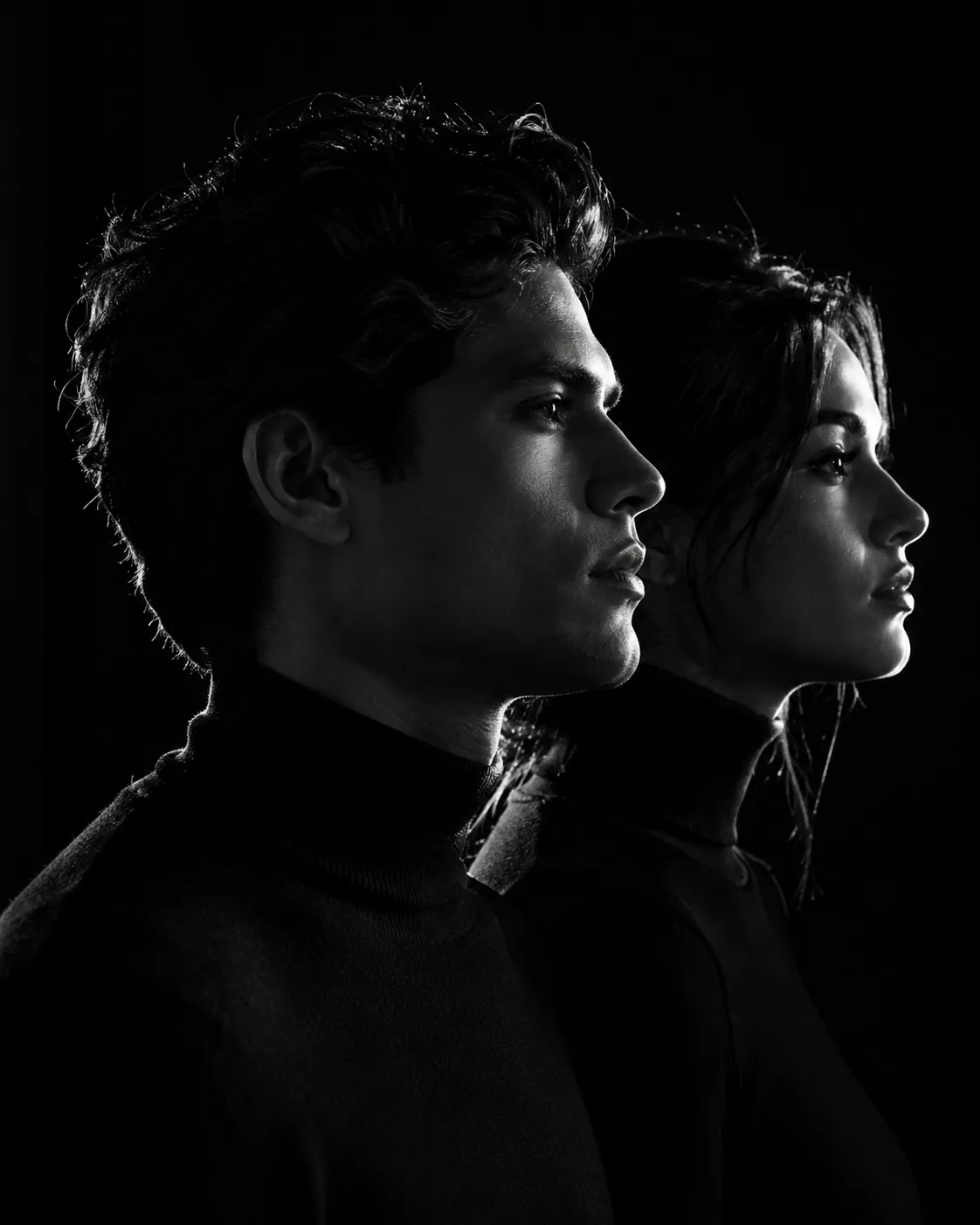 A minimalist black and white cinematic portrait featuring two individuals (male and female) in strict side profile, both facing the same