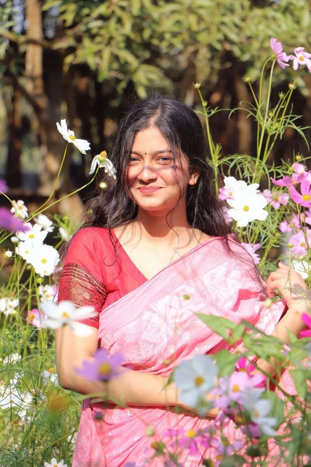 Create a photorealistic portrait of a young woman standing gracefully in a vibrant flower garden.