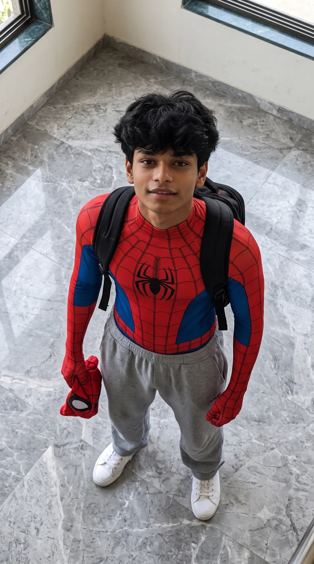 A realistic high-angle full-body shot of a young man with messv, textured black hair looking up at the camera.