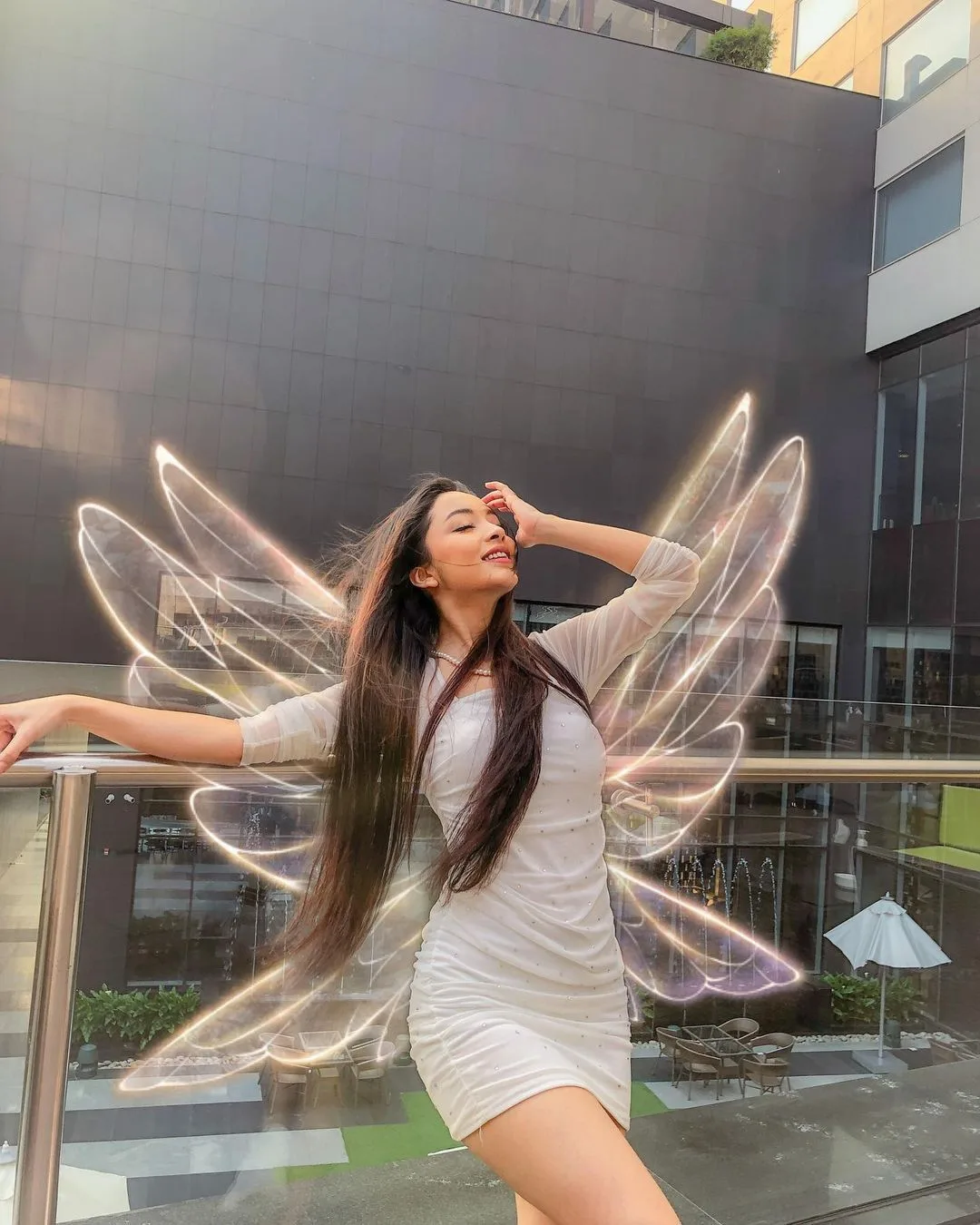 Create an ultra-realistic cinematic vertical portrait of a young woman posing gracefully on an elegant modern outdoor terrace or balcony.