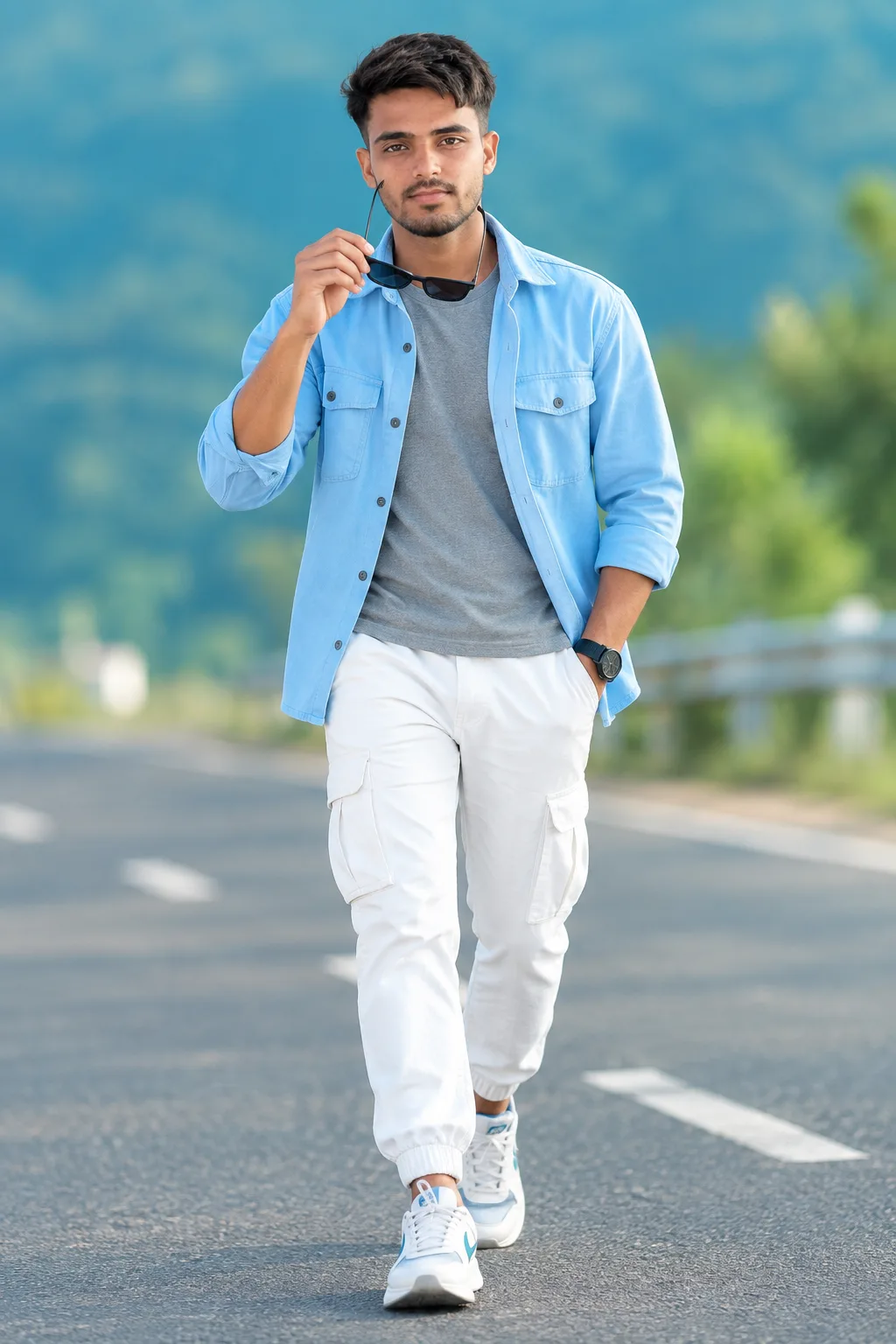 Create a highly realistic full-body outdoor fashion portrait of a young Indian man walking confidently toward the camera on a smooth road.