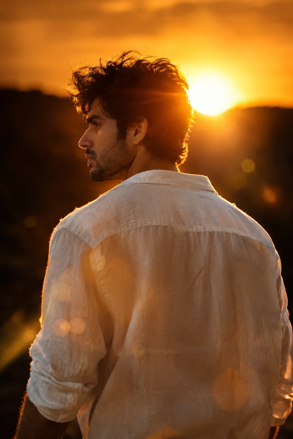 PROMPT Ultra-realistic cinematic portrait of a young man standing with his back toward the camera, wearing a loose white oversized shirt.
