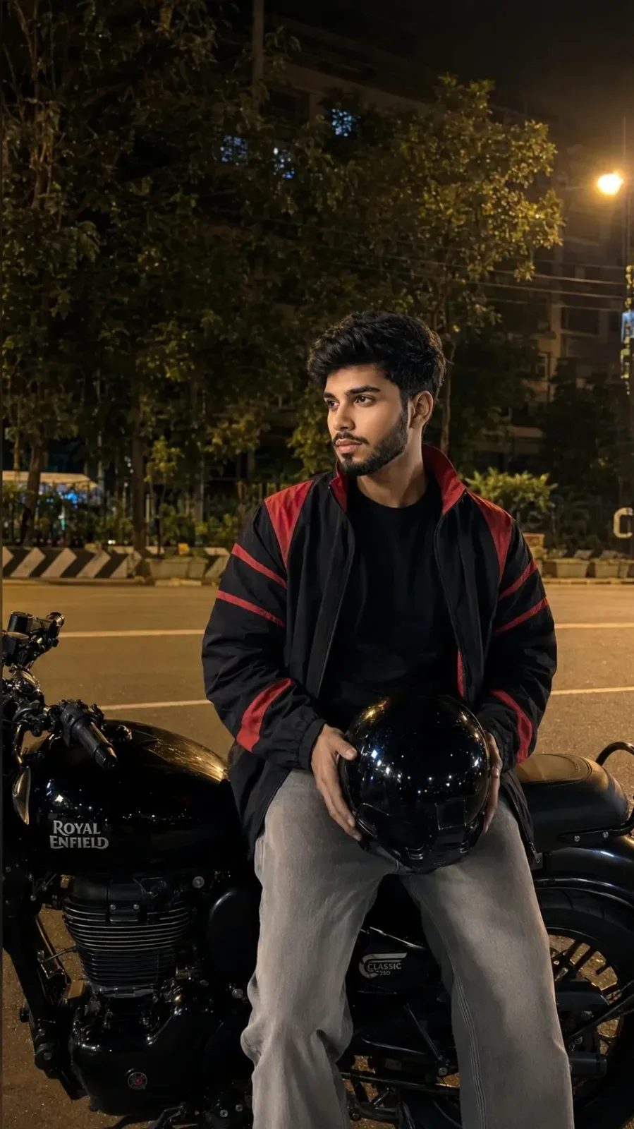 ROYAL Enfield CLASSIC PARKED ON A ROADSIDE AT NIGHT.