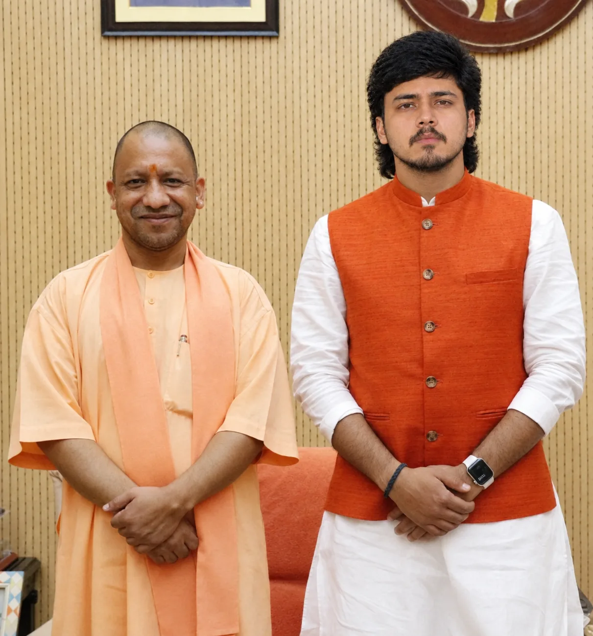 A formal, photorealistic portrait of two Indian men standing side by side inside an elegant official office.