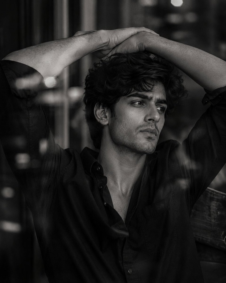 Image created on Gpt 2 Prompt: Ultra-realistic black-and-white cinematic portrait of a strikingly handsome young man in his early 20s,