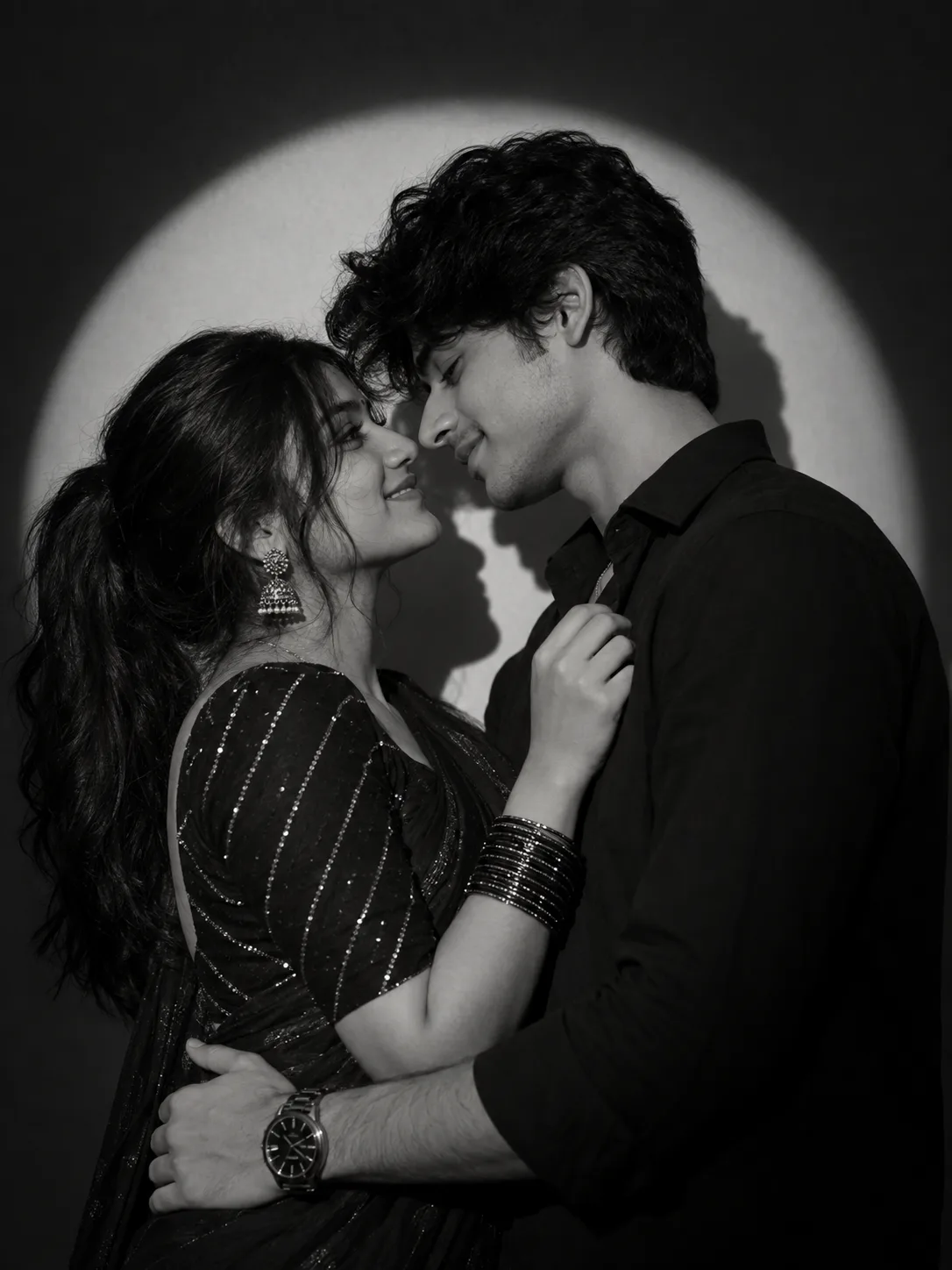 Create A high-contrast, black and white, romantic studio portrait of a couple.