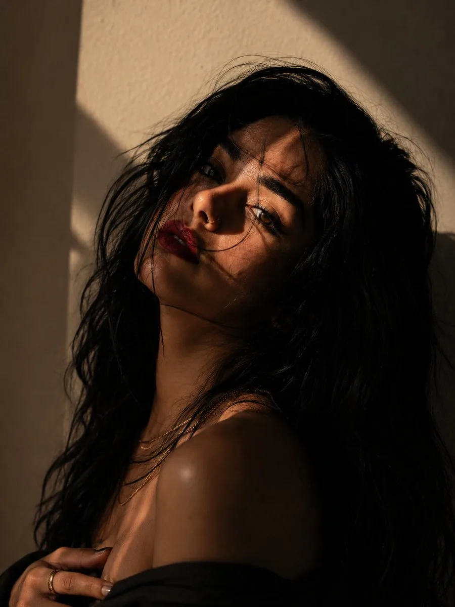 Create an ultra-realistic, cinematic fine-art portrait of a beautiful young woman with a moody, editorial aesthetic.