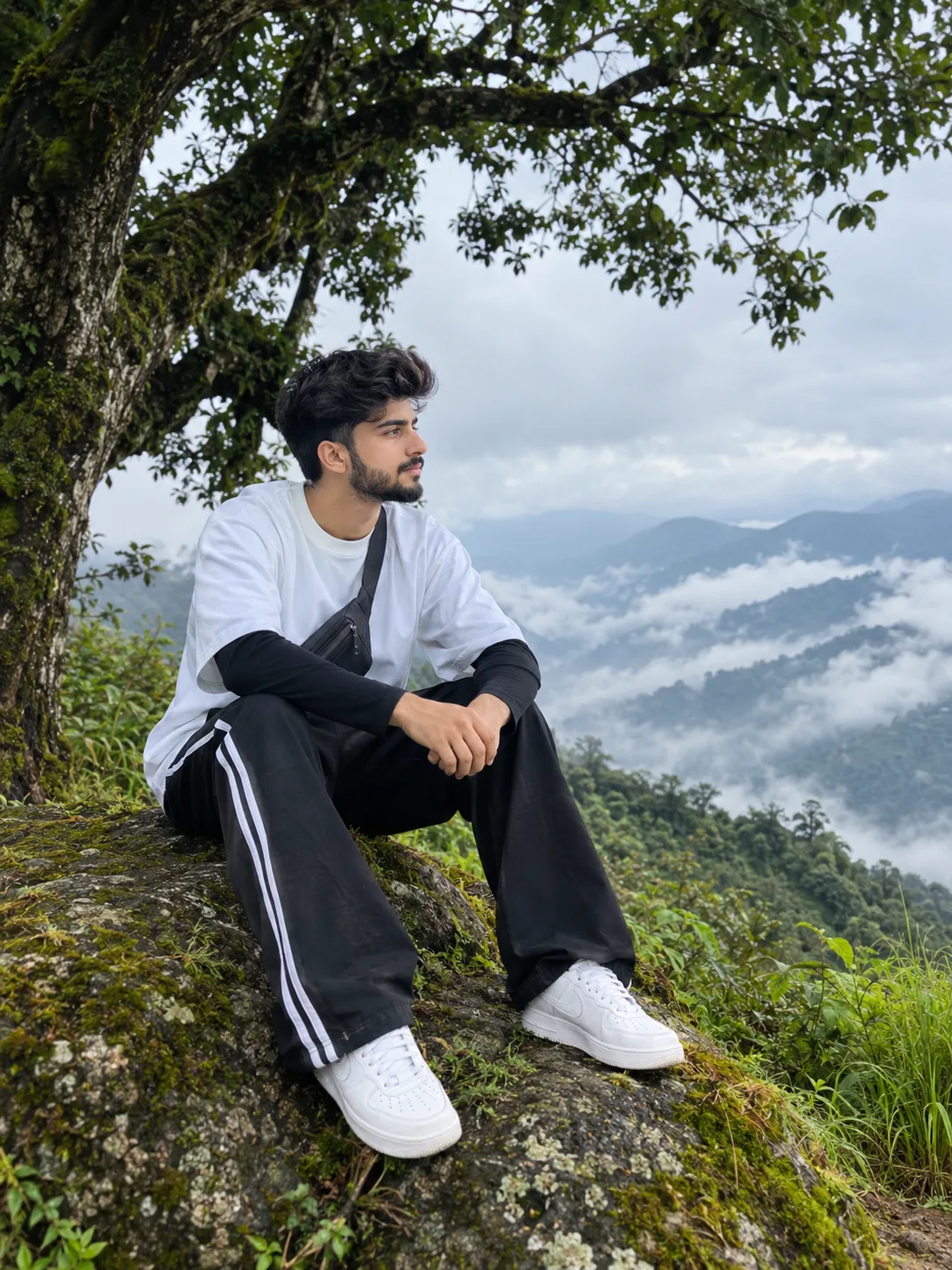 Ultra-realistic cinematic luxury travel portrait of a young South Asian teenage boy sitting peacefully on a large natural rock at a