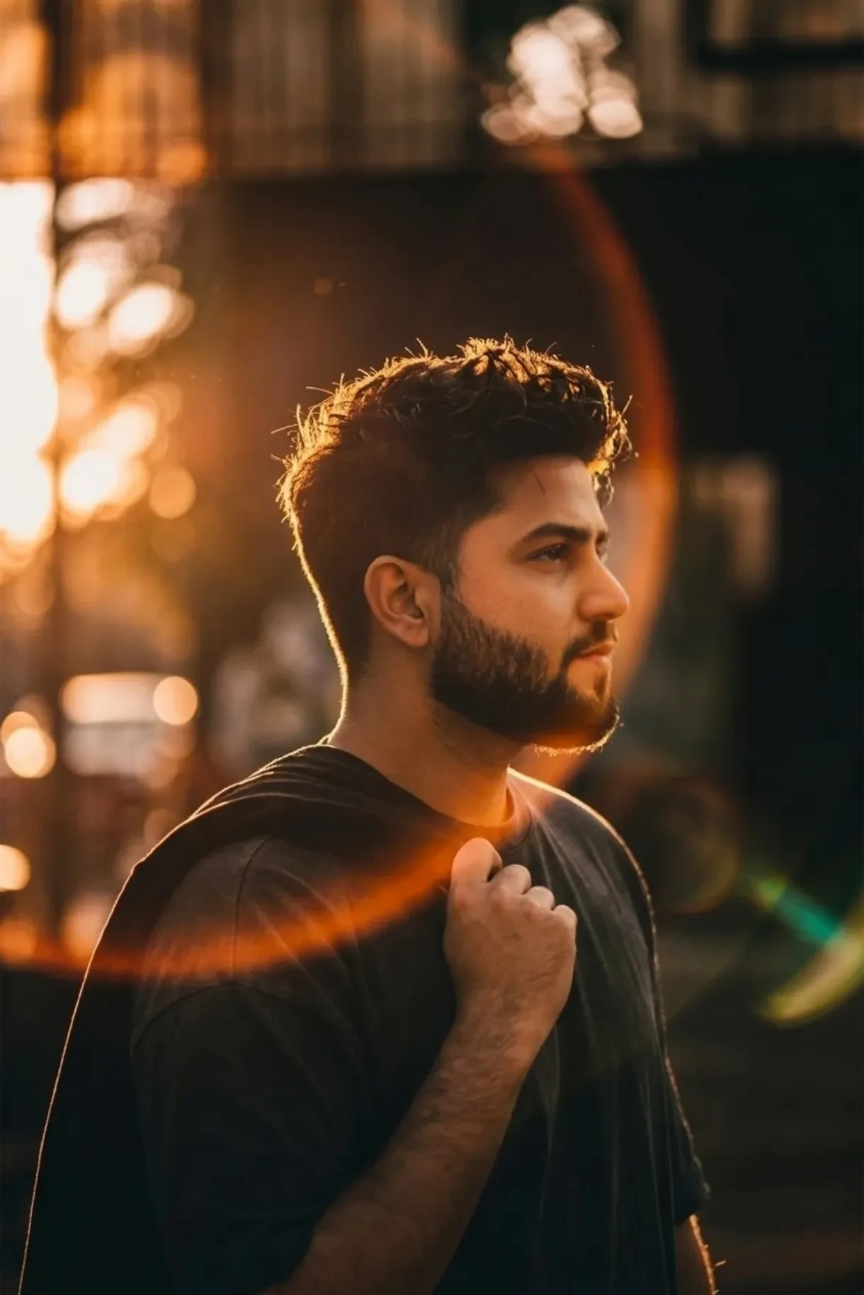 cinematic portrait of a stylish young man standing outdoors at golden hour, captured in dramatic side profile with intense warm sunset