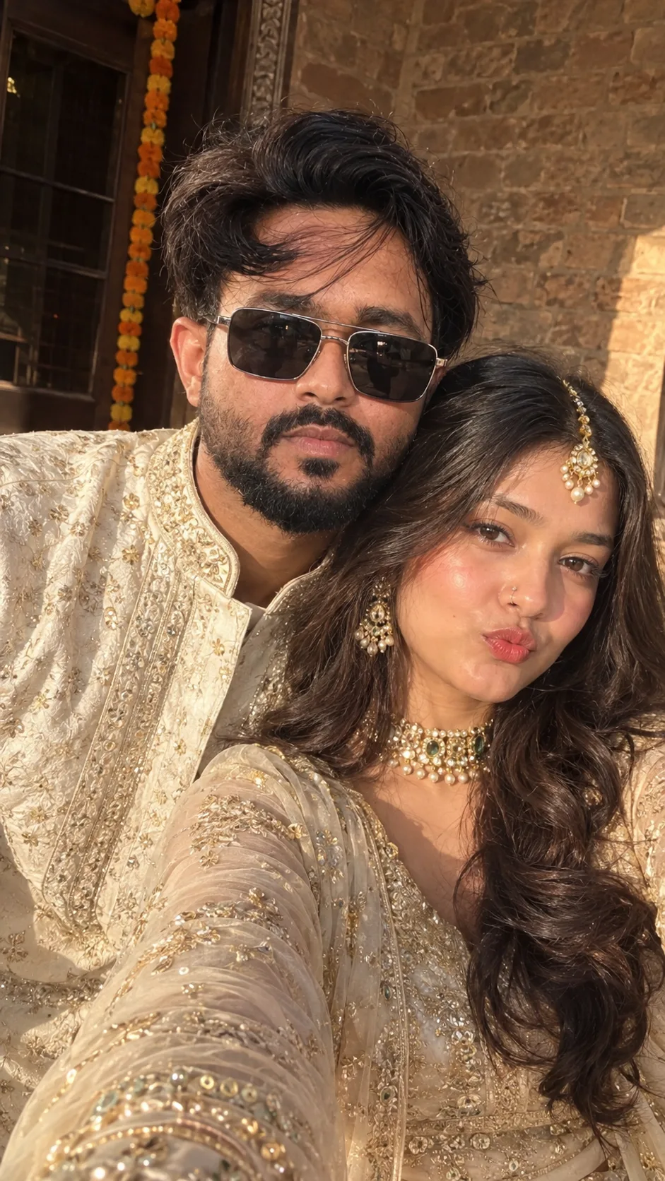 Create a photorealistic, high-end cinematic vertical 9:16 couple selfie, closely inspired by the uploaded reference image.