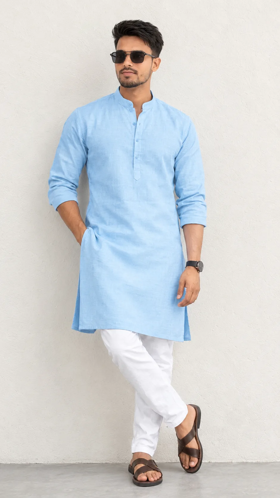 Create a highly realistic full-body fashion portrait of a stylish young South Asian/Indian man standing confidently against a clean
