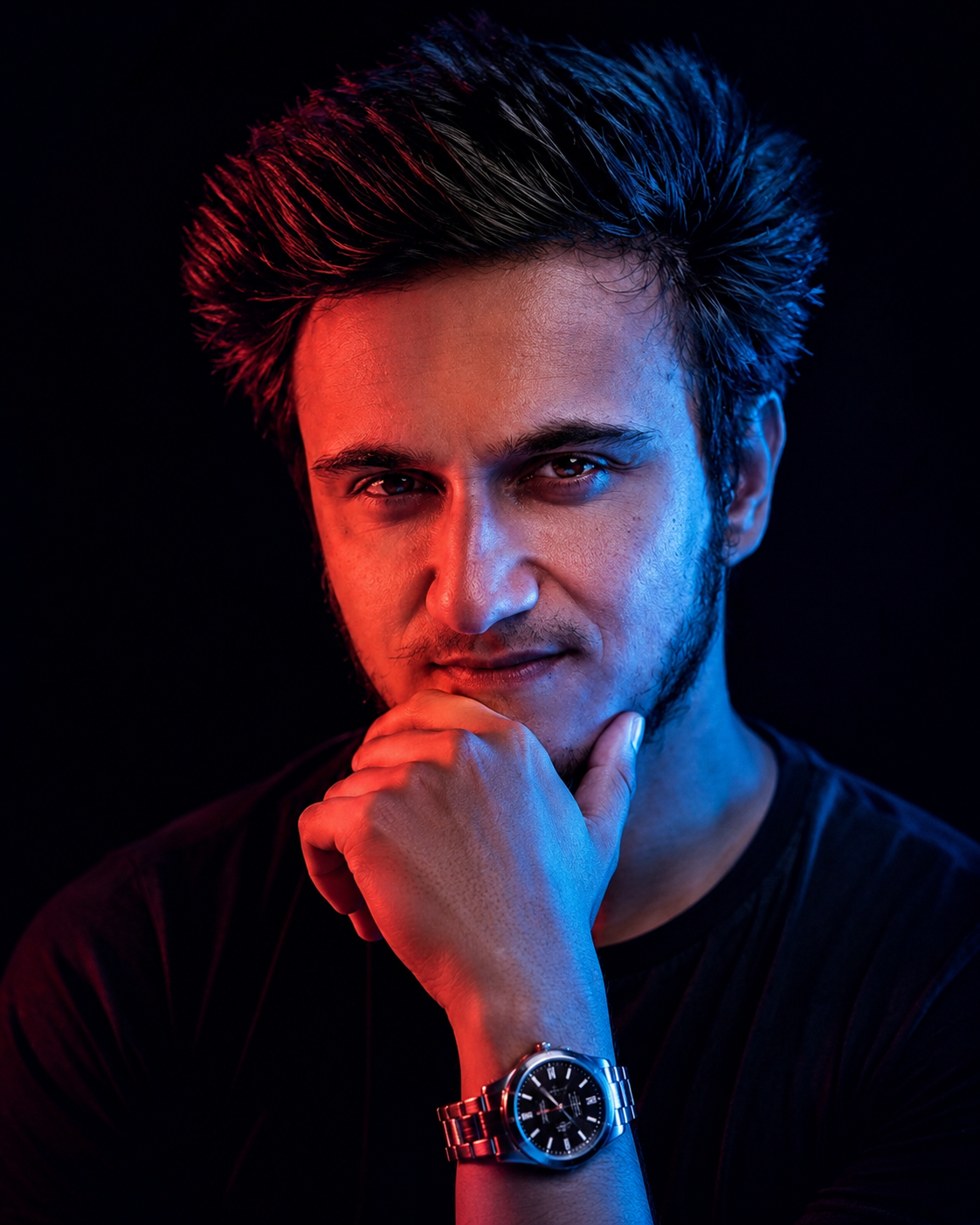 Cinematic close- up portrait of a serious male model with short hair, hand resting on chin, wearing a black t-shirt and a luxury