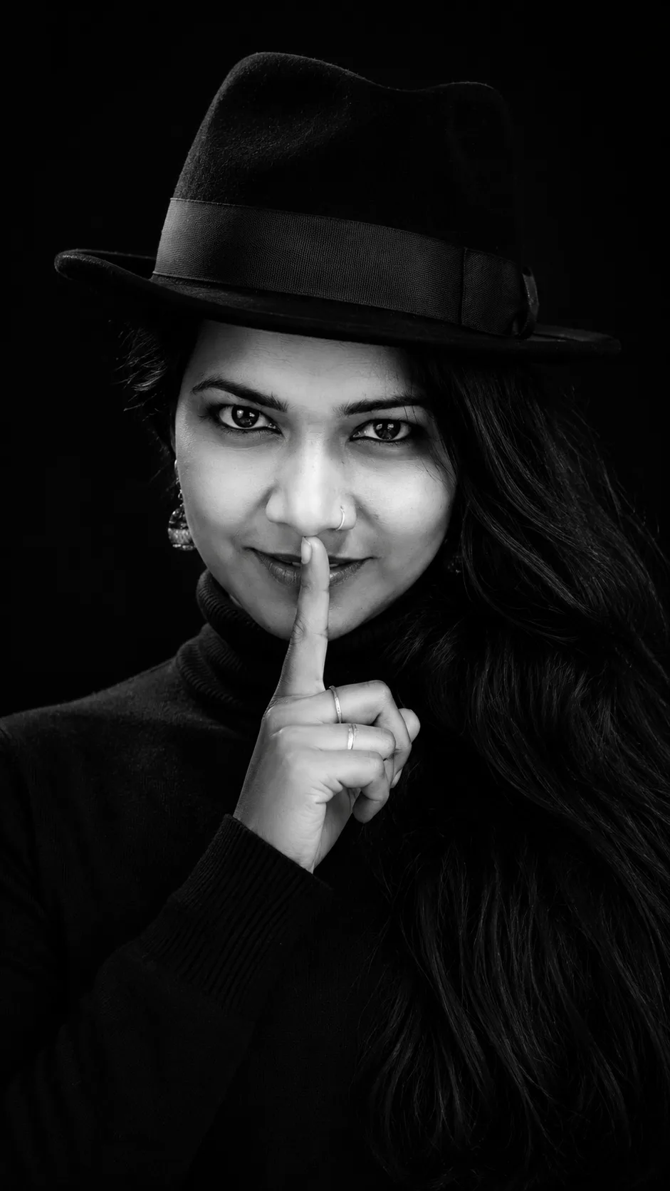 Create a black and white studio portrait, high contrast, photorealistic, 8K.