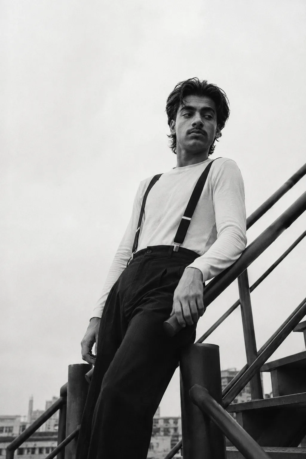 Exact Image Recreation Prompt Create a highly photorealistic cinematic black-and-white fashion editorial photograph of a stylish young