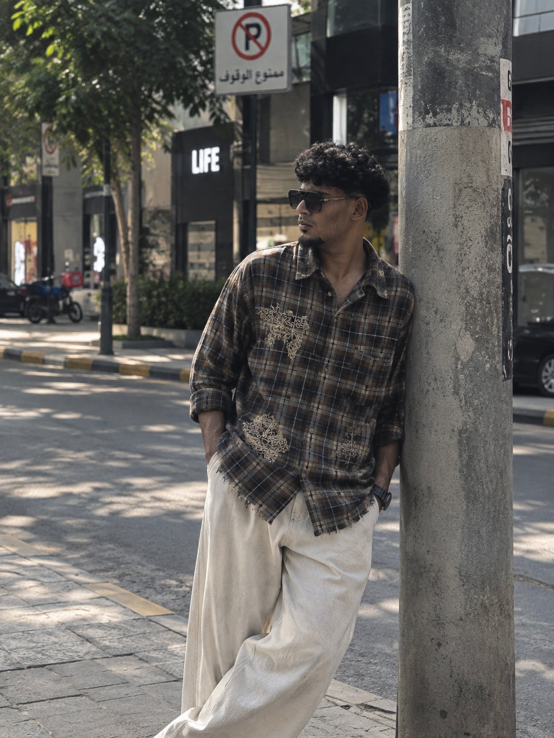 Create an ultra-realistic editorial street photograph using my uploaded face photo as the PRIMARY IDENTITY REFERENCE.