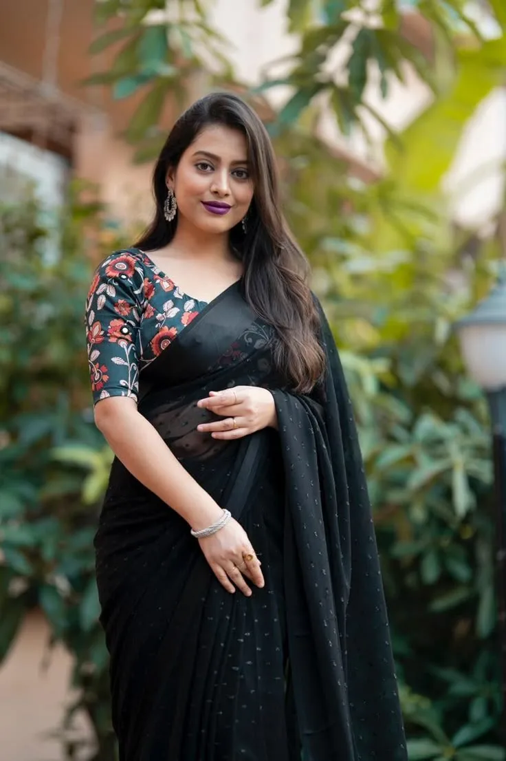 A photorealistic vertical portrait of the Indian woman from the reference image, preserving her exact facial identity, long dark hair,