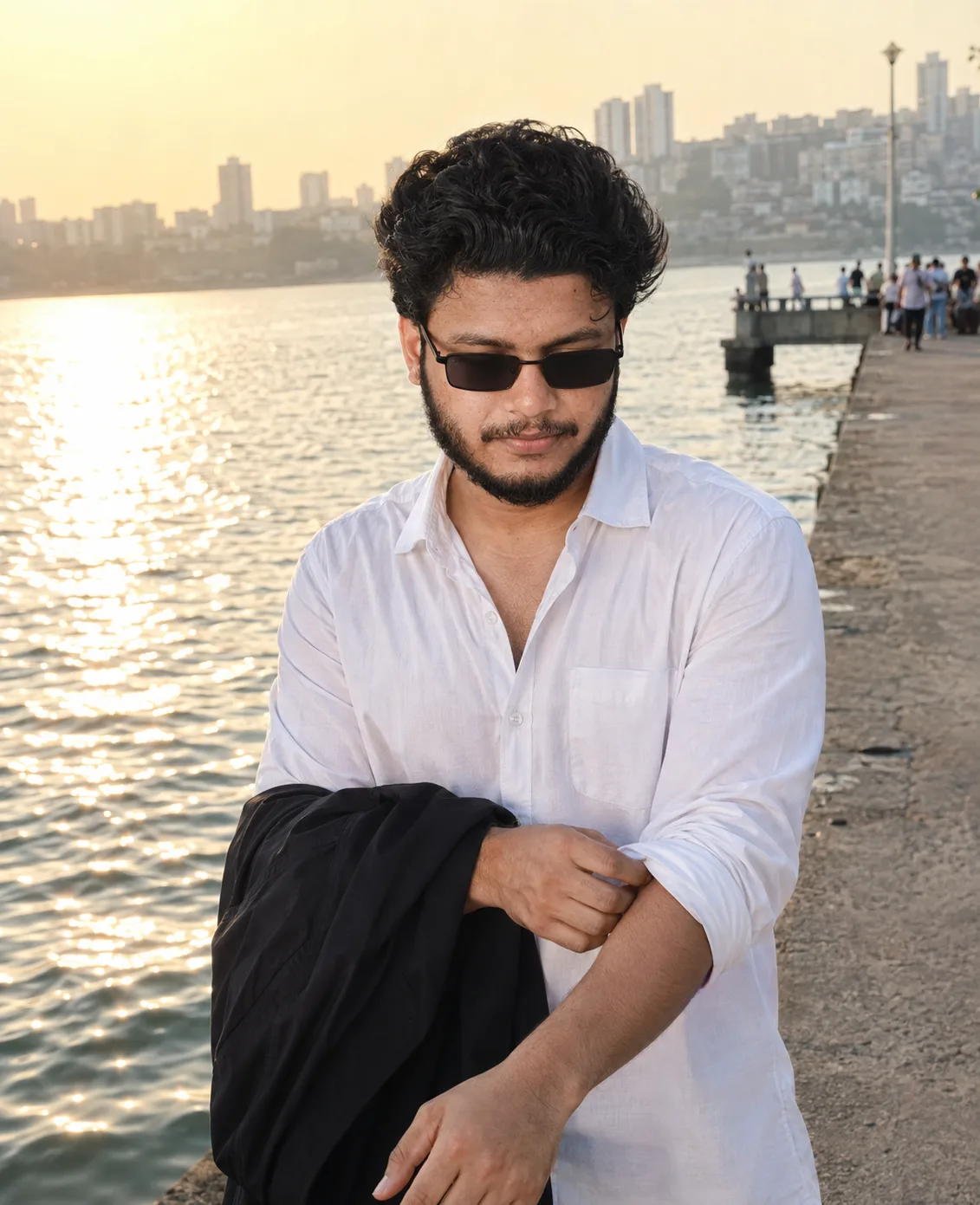 A detailed text prompt to recreate this portrait: A high-resolution, photorealistic portrait of a 26-year-old south Asian man with curly