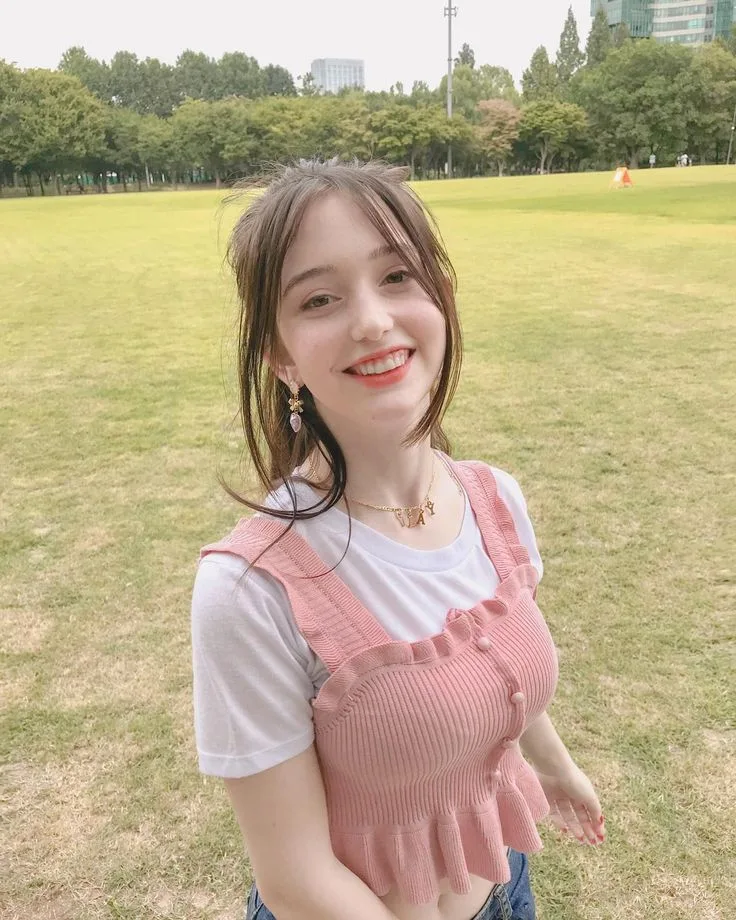 **Prompt:** Ultra-realistic 4K DSLR portrait of a beautiful young woman standing in a lush green park on a bright, overcast day.