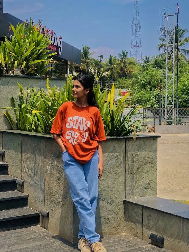 A photorealistic vertical full-length shot of the young South Asian woman from the reference image, faithfully preserving her exact