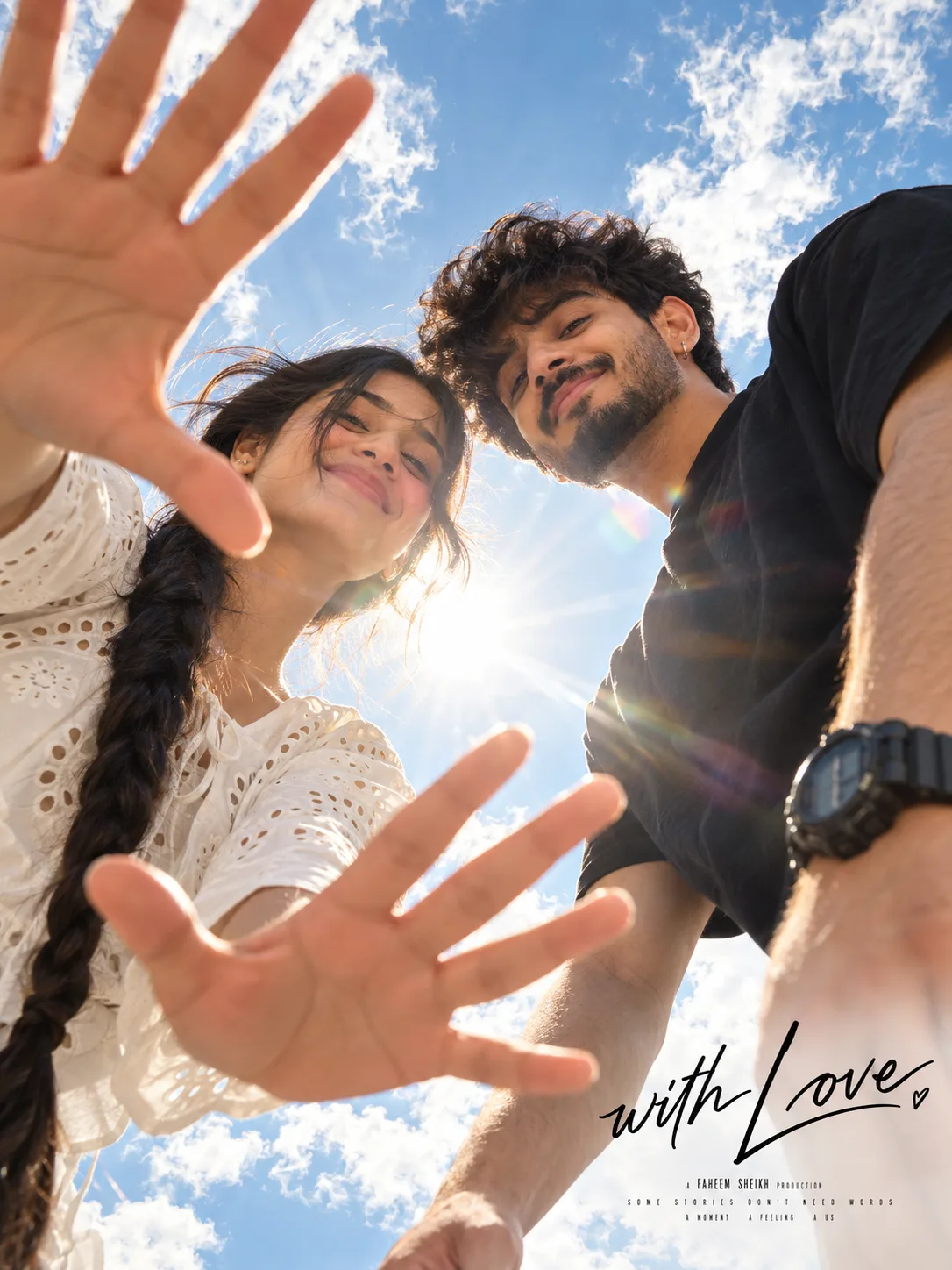 An extreme low angle, worm's-eye view movie poster style shot of a happy young Indian couple looking down toward the camera.