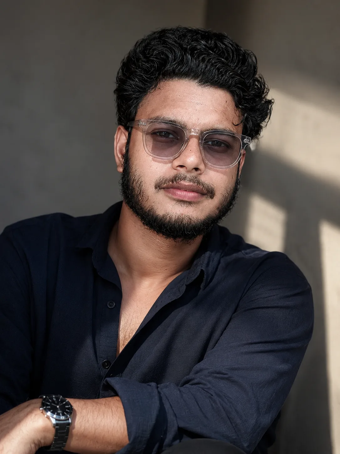 Without chaging face features, create a stylish, modern portrait of a young man with voluminousdarkhair,wearing a loose-fitting Navy Blue