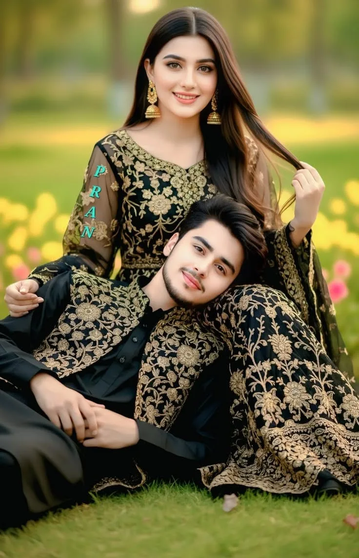 A highly detailed, photorealistic full-body portrait of a beautiful young South Asian couple posing together outdoors on a lush green lawn.