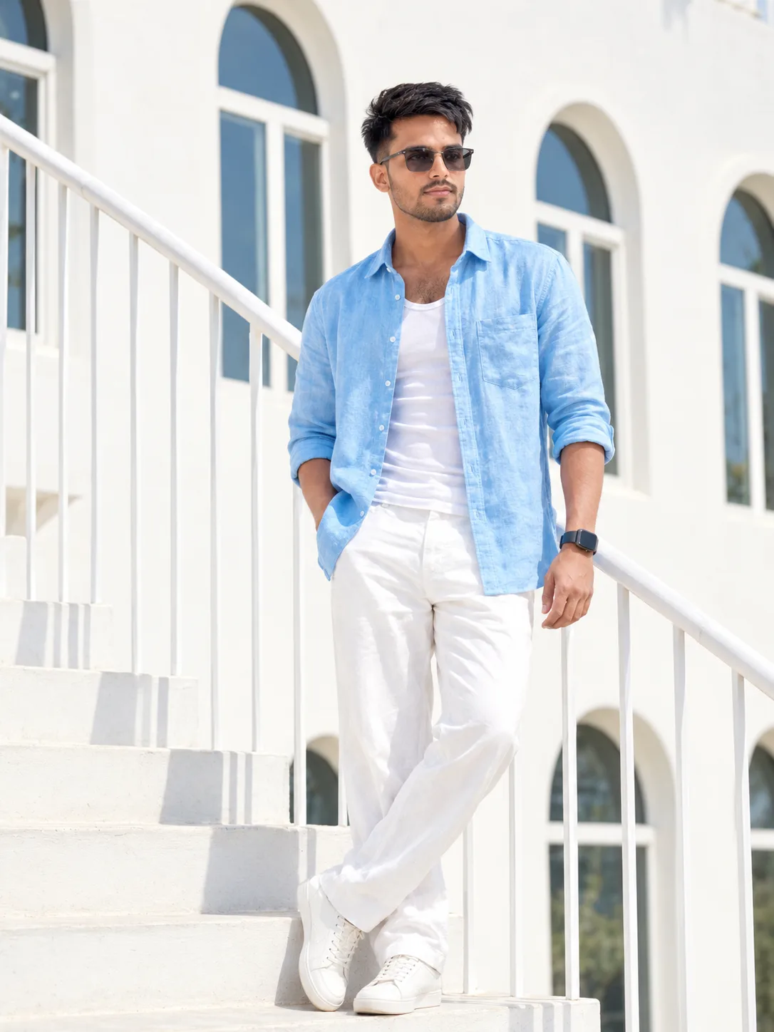 Create a highly realistic full-body fashion portrait of a stylish young South Asian/Indian man standing confidently on a bright white