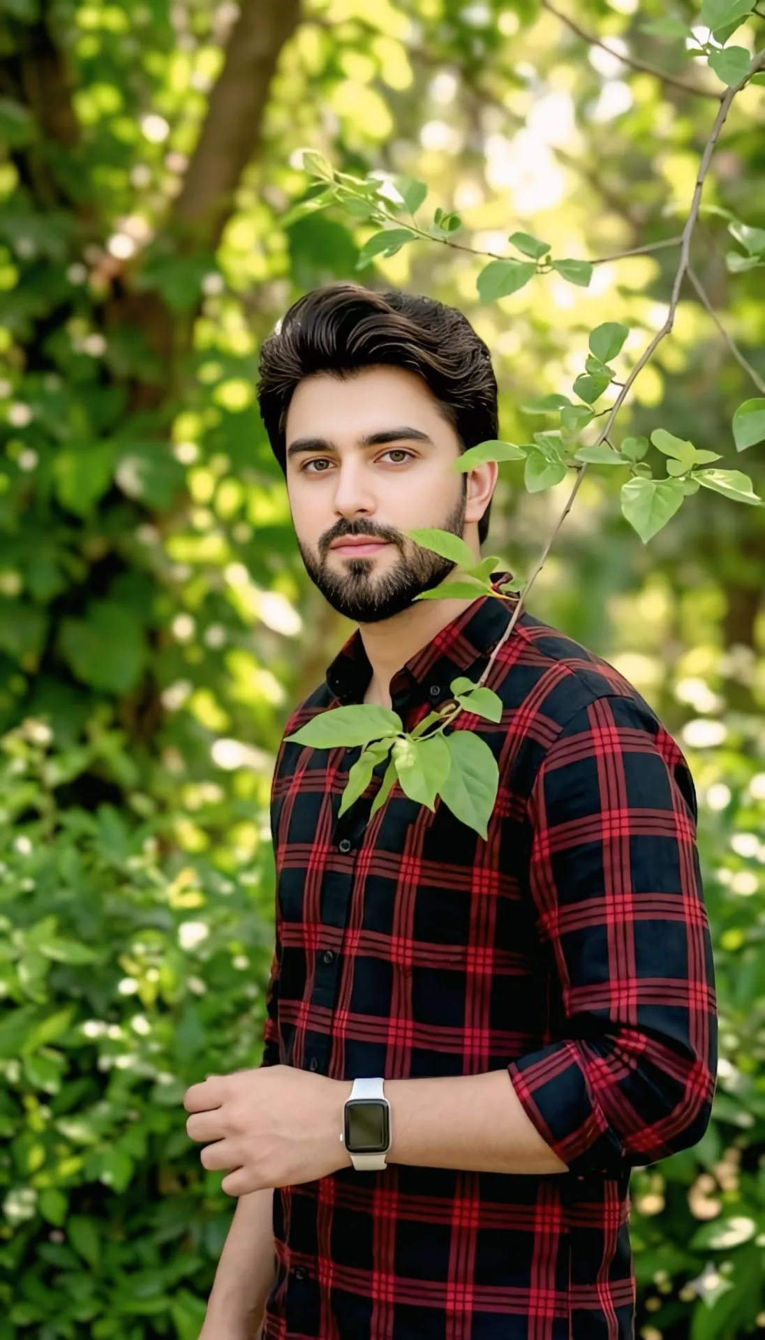A high-quality medium shot portrait of a handsome South Asian young man with styled, voluminous dark hair, a perfectly groomed beard, and