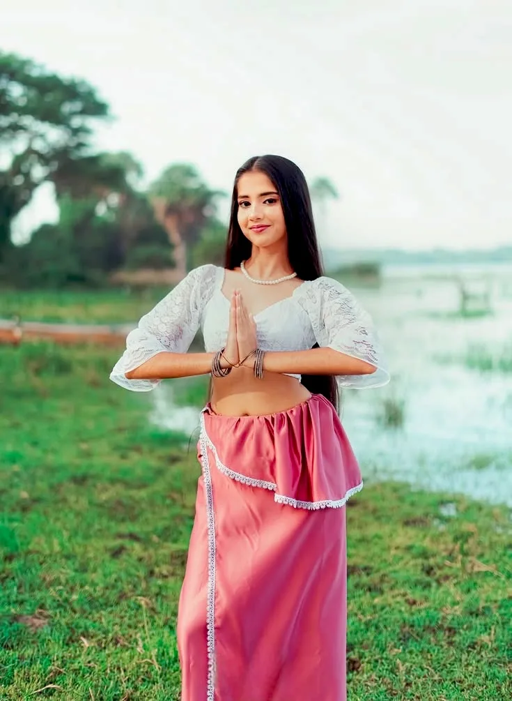 A photorealistic vertical medium-three-quarter portrait in 3:4 aspect ratio of the young South Asian woman from the reference image