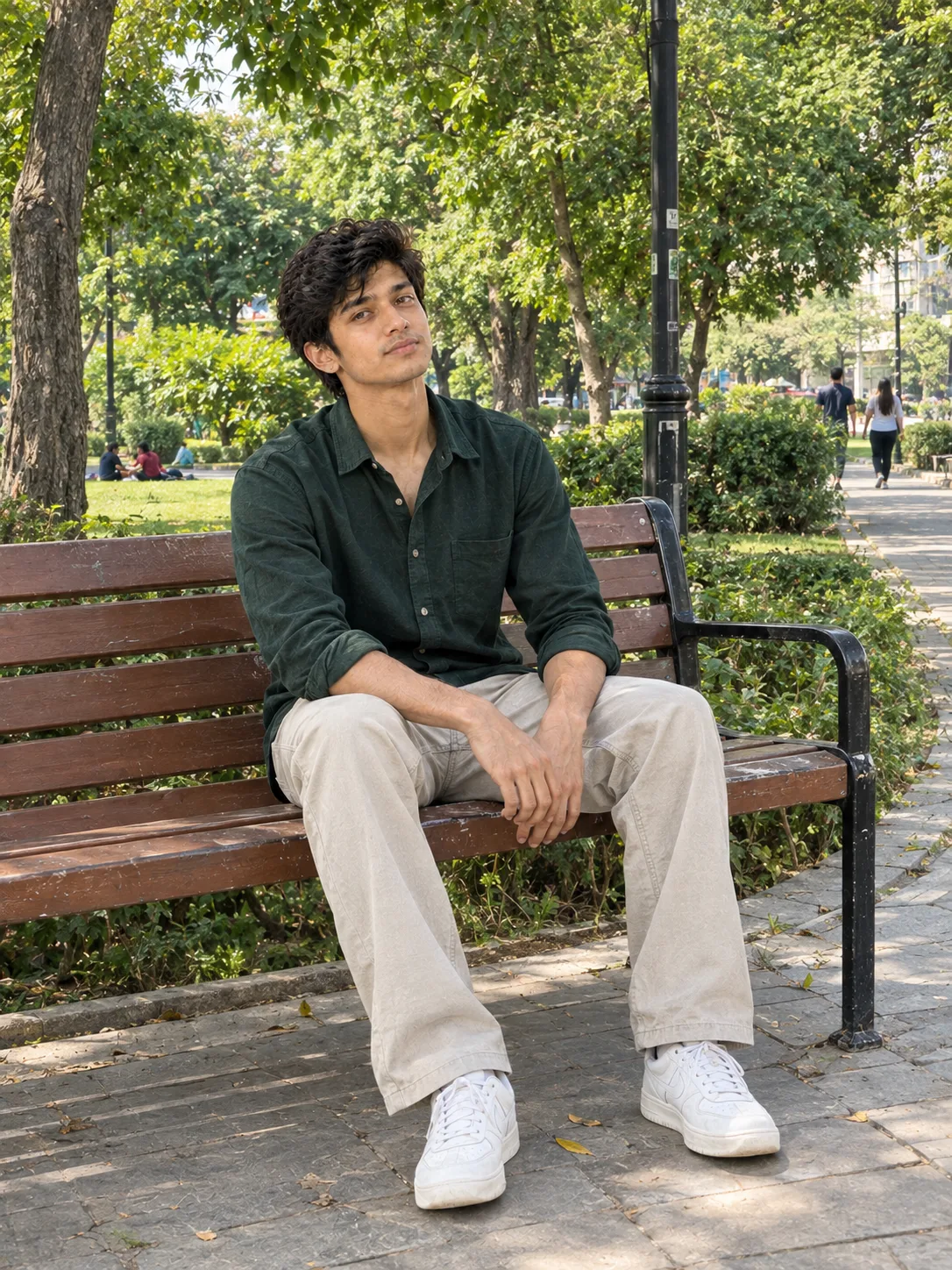 A highly detailed realistic photograph of a young man sitting on a wooden park bench during daytime.