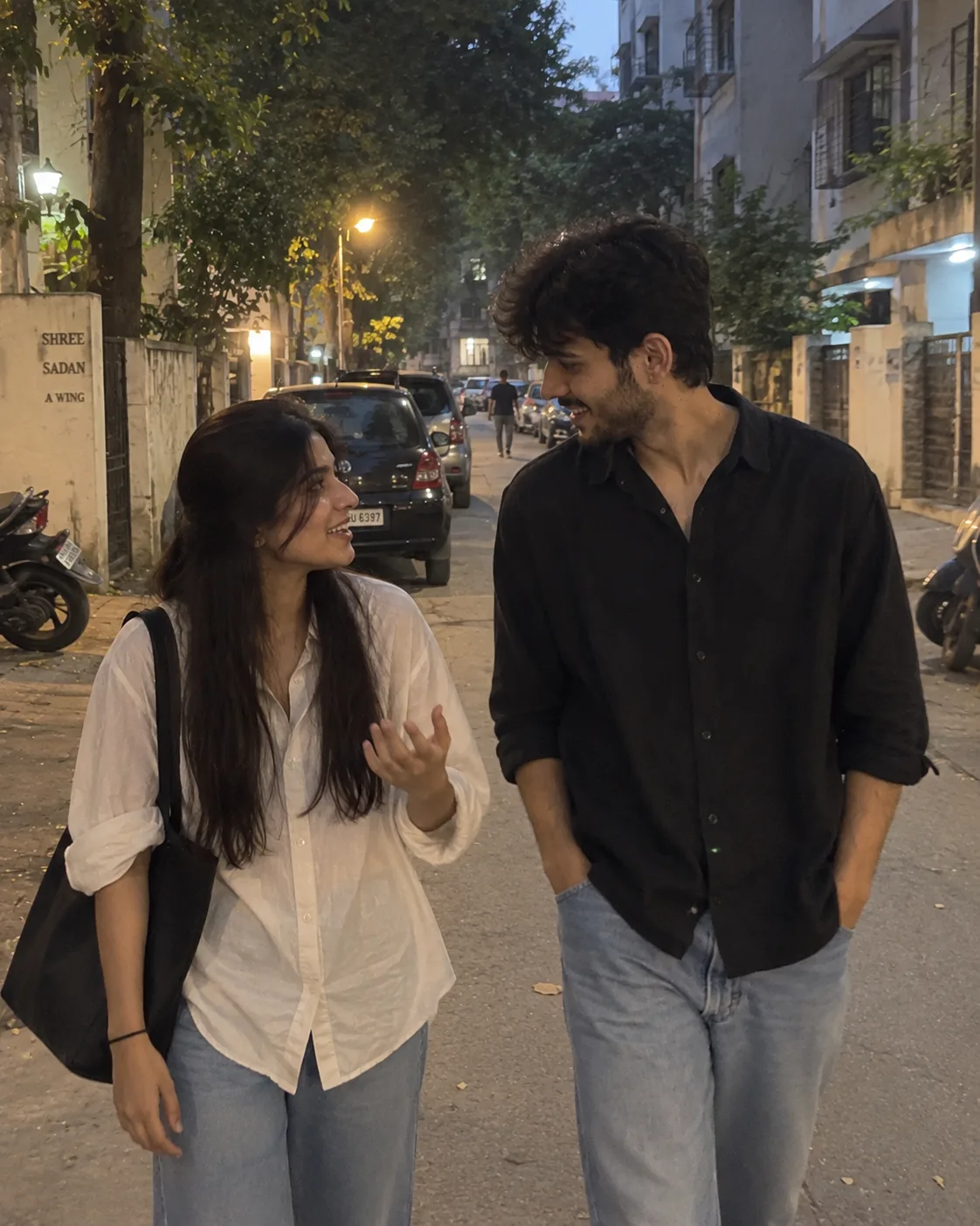 Photorealistic 4:5 vertical iPhone photo of a young Indian couple casually walking together on a normal Mumbai residential street in the