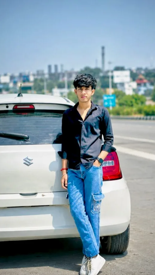 A photorealistic full-body vertical portrait of the young South Asian man from the reference image, faithfully preserving his exact