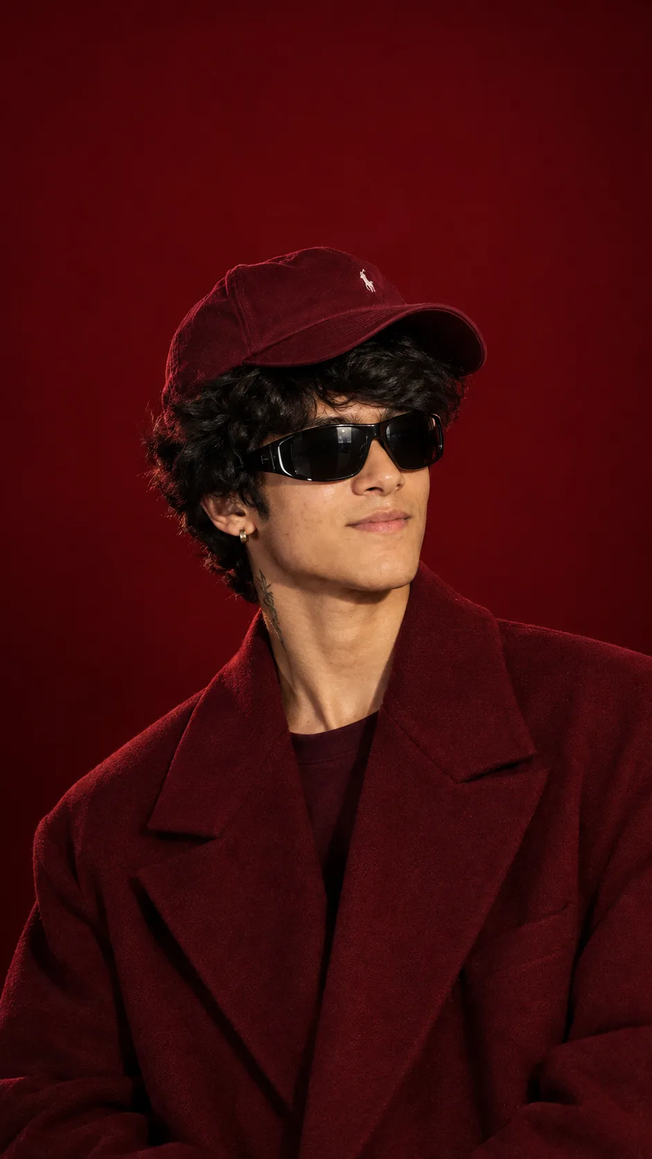 Create a striking vertical 9:16 ultra-realistic cinematic luxury fashion portrait of the SAME young adult man from the provided reference