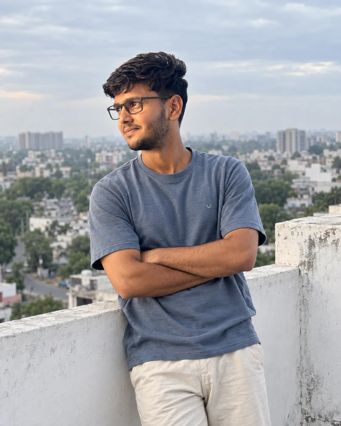 πΈ Exact Image Generation Prompt Create an ultra-realistic candid rooftop portrait of a young adult South Asian man, closely matching the