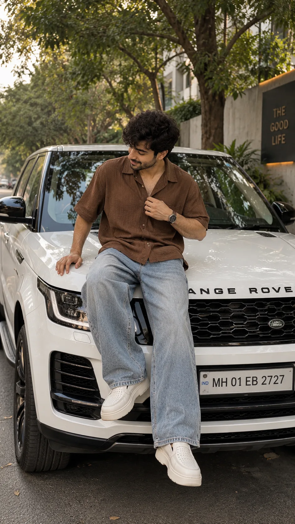 Create an ultra-realistic, natural cinematic full-body vertical 9:16 fashion photograph of a young South Asian/Indian man casually sitting
